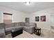 Neutral toned living room with sectional sofa, decor, and view of a doorway to another room at 344 Nottingham Dr, Marietta, GA 30066