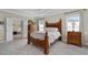 Main bedroom with a tray ceiling, plenty of natural light, and an attached ensuite at 344 Nottingham Dr, Marietta, GA 30066