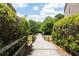 Charming community pathway lined with lush greenery and wooden fences, leading to scenic views and a relaxing stroll at 344 Nottingham Dr, Marietta, GA 30066