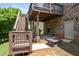 Outdoor patio with a fire pit and furniture set, situated under the deck with stairs to access the backyard at 344 Nottingham Dr, Marietta, GA 30066