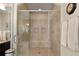 Modern tiled shower with frameless glass door and built-in bench and shelves at 344 Nottingham Dr, Marietta, GA 30066