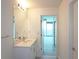 Bright bathroom featuring a vanity with white countertop and a view from the door at 361 17Th, Chattahoochee Hills, GA 30363