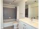 Modern bathroom featuring a bathtub with gray tile surround, and a vanity with a white countertop at 361 17Th, Chattahoochee Hills, GA 30363