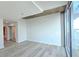Bedroom with luxury vinyl plank flooring, ensuite bathroom, and large windows offering scenic views at 361 17Th, Chattahoochee Hills, GA 30363