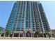 Exterior of a modern high-rise building featuring balconies and numerous windows against a clear, blue sky at 361 17Th, Chattahoochee Hills, GA 30363