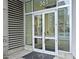 Building entrance with glass doors, signage, and welcoming mat at 361 17Th, Chattahoochee Hills, GA 30363