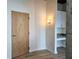 Entryway with wood door, luxury vinyl plank flooring, and a built-in desk area featuring a mosaic tile backsplash at 361 17Th, Chattahoochee Hills, GA 30363