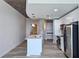 Open kitchen with stainless steel appliances, an island with marble countertop, and stylish pendant lighting at 361 17Th, Chattahoochee Hills, GA 30363