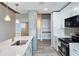 Modern kitchen with stainless steel appliances and a center island featuring a marble countertop and gold hardware at 361 17Th, Chattahoochee Hills, GA 30363