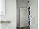 Convenient laundry area with stacked washer and dryer next to the kitchen counter at 361 17Th, Chattahoochee Hills, GA 30363