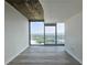 Bright living room featuring a bare concrete ceiling and expansive windows offering city views at 361 17Th, Chattahoochee Hills, GA 30363