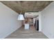 Open living room leading into the kitchen, featuring luxury vinyl plank flooring and exposed concrete ceilings at 361 17Th, Chattahoochee Hills, GA 30363