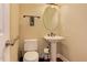 Cozy powder room featuring a pedestal sink, toilet, and hand towel, maximizing space and functionality at 4924 Locklear Way, Marietta, GA 30066