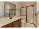 Bathroom showcasing a glass shower, marble counters, and vanity with dark brown cabinets at 4924 Locklear Way, Marietta, GA 30066