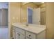 A well-lit bathroom features a vanity with white cabinets, a large mirror, and access to a shower at 4924 Locklear Way, Marietta, GA 30066