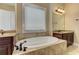 Luxurious bathroom featuring a soaking tub, double vanity, and tile surround, offering a spa-like experience at 4924 Locklear Way, Marietta, GA 30066