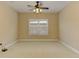 A bright and spacious bedroom features neutral walls, carpet and a ceiling fan with light fixture at 4924 Locklear Way, Marietta, GA 30066