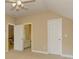 A bedroom features multiple doorways and a ceiling fan; the space is bright with neutral paint at 4924 Locklear Way, Marietta, GA 30066