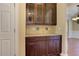 Butler pantry with rich wood cabinets, granite counters, and tile backsplash at 4924 Locklear Way, Marietta, GA 30066