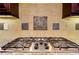 Close up of the six-burner stainless cooktop with pot filler, granite countertop and designer backsplash at 4924 Locklear Way, Marietta, GA 30066