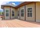 Open back porch with a warm stain showcases multiple windows and decorative molding along the tan siding at 4924 Locklear Way, Marietta, GA 30066