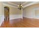 Open-concept dining room with hardwood floors, chandelier and archways to other rooms at 4924 Locklear Way, Marietta, GA 30066