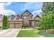 Two-story brick home boasts a well-manicured lawn and a two-car garage at 4924 Locklear Way, Marietta, GA 30066