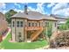 Rear view of home with a cozy deck, lush green lawn, and beautiful landscaping enhancing curb appeal at 4924 Locklear Way, Marietta, GA 30066