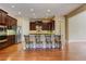 Eat-in kitchen features stainless appliances, dark cabinetry, and center island with seating at 4924 Locklear Way, Marietta, GA 30066