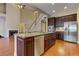 Kitchen with stainless appliances and island flows into breakfast room and living area at 4924 Locklear Way, Marietta, GA 30066