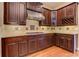 Gourmet kitchen boasts cooktop, updated cabinetry, granite countertops and stainless-steel appliances at 4924 Locklear Way, Marietta, GA 30066