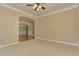 Spacious living area featuring plush carpeting and an arched doorway to the hallway at 4924 Locklear Way, Marietta, GA 30066