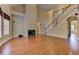 Spacious living room with hardwood floors, fireplace and view of staircase to the second floor at 4924 Locklear Way, Marietta, GA 30066