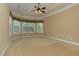 Spacious main bedroom with neutral carpet, trey ceiling, and large windows at 4924 Locklear Way, Marietta, GA 30066