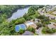 Aerial view of neighborhood amenities including a pool, tennis courts, and a picturesque lake at 6045 Stargazer Way, Cumming, GA 30028