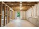 Large unfinished basement space showing insulation, framing, lighting and window to the backyard at 6045 Stargazer Way, Cumming, GA 30028