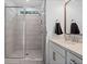 Contemporary bathroom with a glass-enclosed shower featuring tiled walls and sleek fixtures at 6045 Stargazer Way, Cumming, GA 30028
