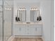 Well-appointed bathroom featuring double sinks, modern lighting, and a sleek glass-enclosed shower at 6045 Stargazer Way, Cumming, GA 30028