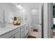Bright bathroom featuring double sinks with modern fixtures, white cabinets, and a walk-in shower at 6045 Stargazer Way, Cumming, GA 30028
