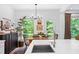 Dining area featuring a wood table, pendant lighting, dark wood credenza and view to a deck at 6045 Stargazer Way, Cumming, GA 30028