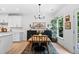 Dining area featuring a wood table, black chairs and dark wood credenza at 6045 Stargazer Way, Cumming, GA 30028