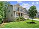 Lovely two-story home has a welcoming front porch, a well-kept yard, and a convenient three-car garage at 6045 Stargazer Way, Cumming, GA 30028