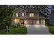 Charming two-story home with a welcoming front porch, well-manicured lawn, and three-car garage at 6045 Stargazer Way, Cumming, GA 30028