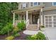 Cozy front porch with brick accents, decorative plants, and a welcoming entrance, perfect for relaxing at 6045 Stargazer Way, Cumming, GA 30028