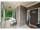 Charming front porch featuring a comfortable seating area, stylish decor, and a welcoming front door at 6045 Stargazer Way, Cumming, GA 30028