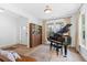 Welcoming living area with a grand piano, wooden bookcase and neutral color scheme at 6045 Stargazer Way, Cumming, GA 30028