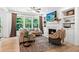 Bright living room featuring a fireplace, built-in shelves and large windows at 6045 Stargazer Way, Cumming, GA 30028