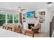 Bright living room with a fireplace, built-in shelves and view to the kitchen island at 6045 Stargazer Way, Cumming, GA 30028