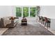 Inviting living room with a neutral color palette, large windows, and a view of the outdoors at 6045 Stargazer Way, Cumming, GA 30028