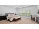 Spacious main bedroom with a tray ceiling, a sitting area, and a large window overlooking the backyard at 6045 Stargazer Way, Cumming, GA 30028